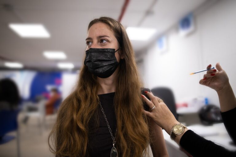 A woman is getting vaccinated