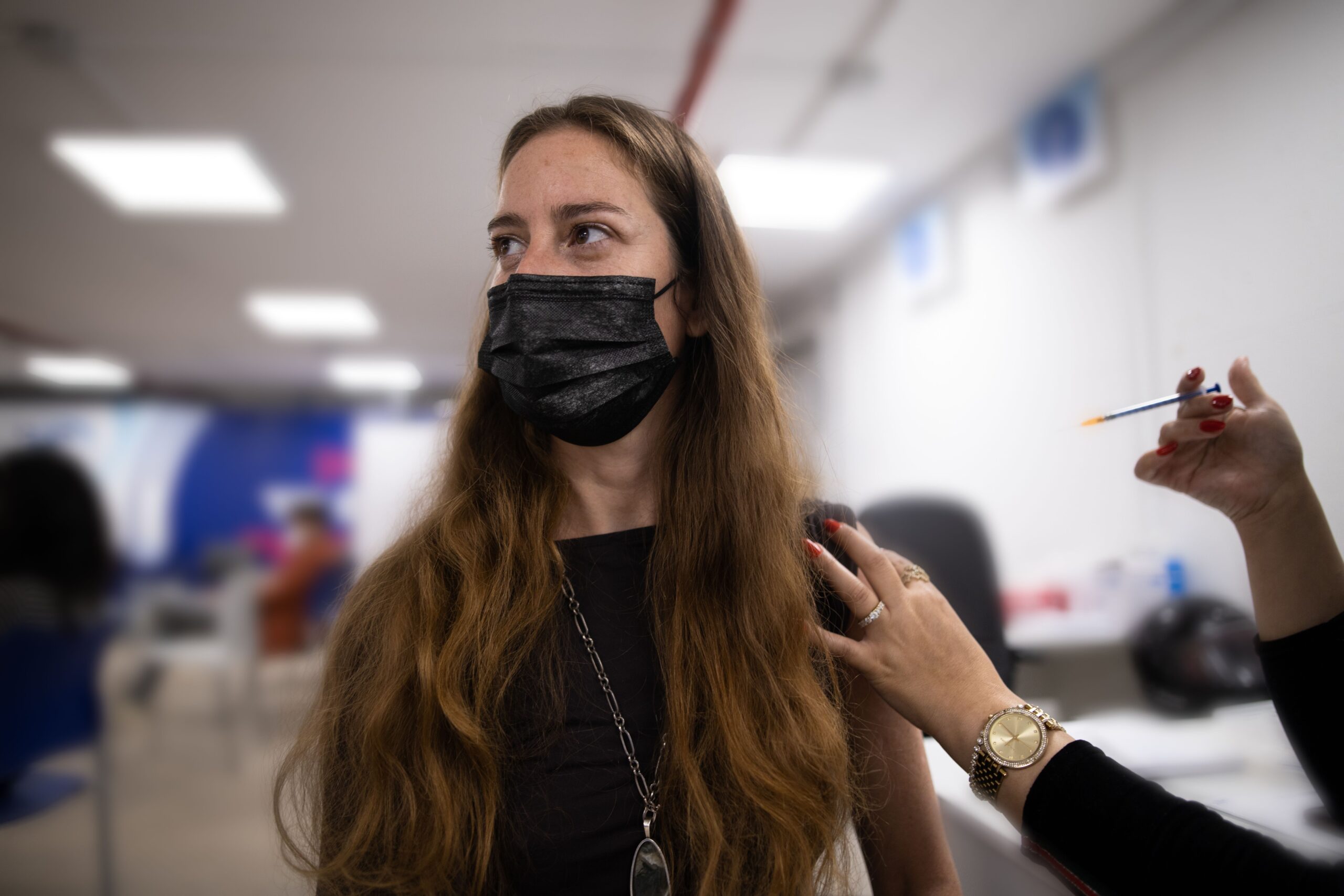 A woman is getting vaccinated