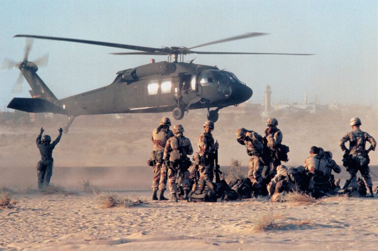 American soldier next to helicopter