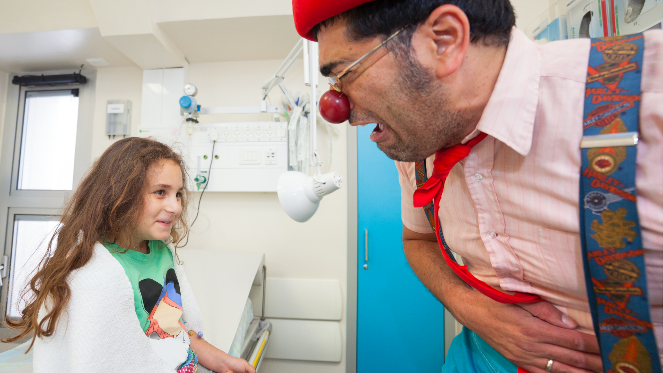 Image of a child in hospital, being entertained by a medical clown.