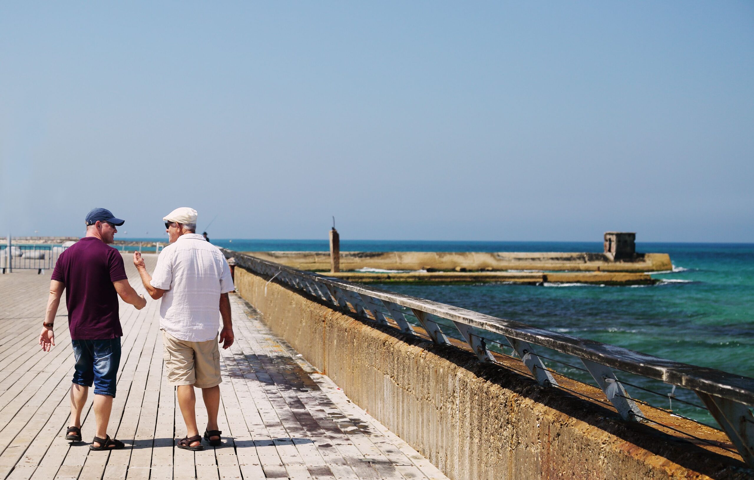 Father and Son walking on the board walk in Tel Aviv