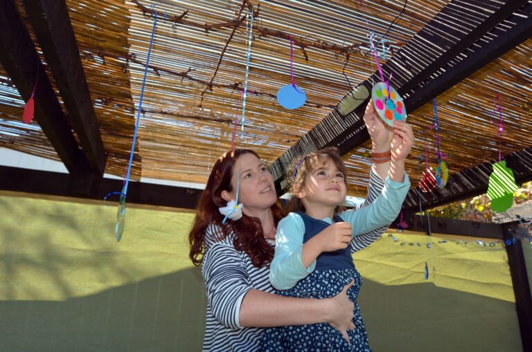 Mother and child decorating the sukka